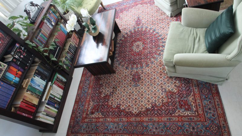 Close-up of a Persian rug with intricate patterns and vibrant colors, adding a touch of elegance to any room.