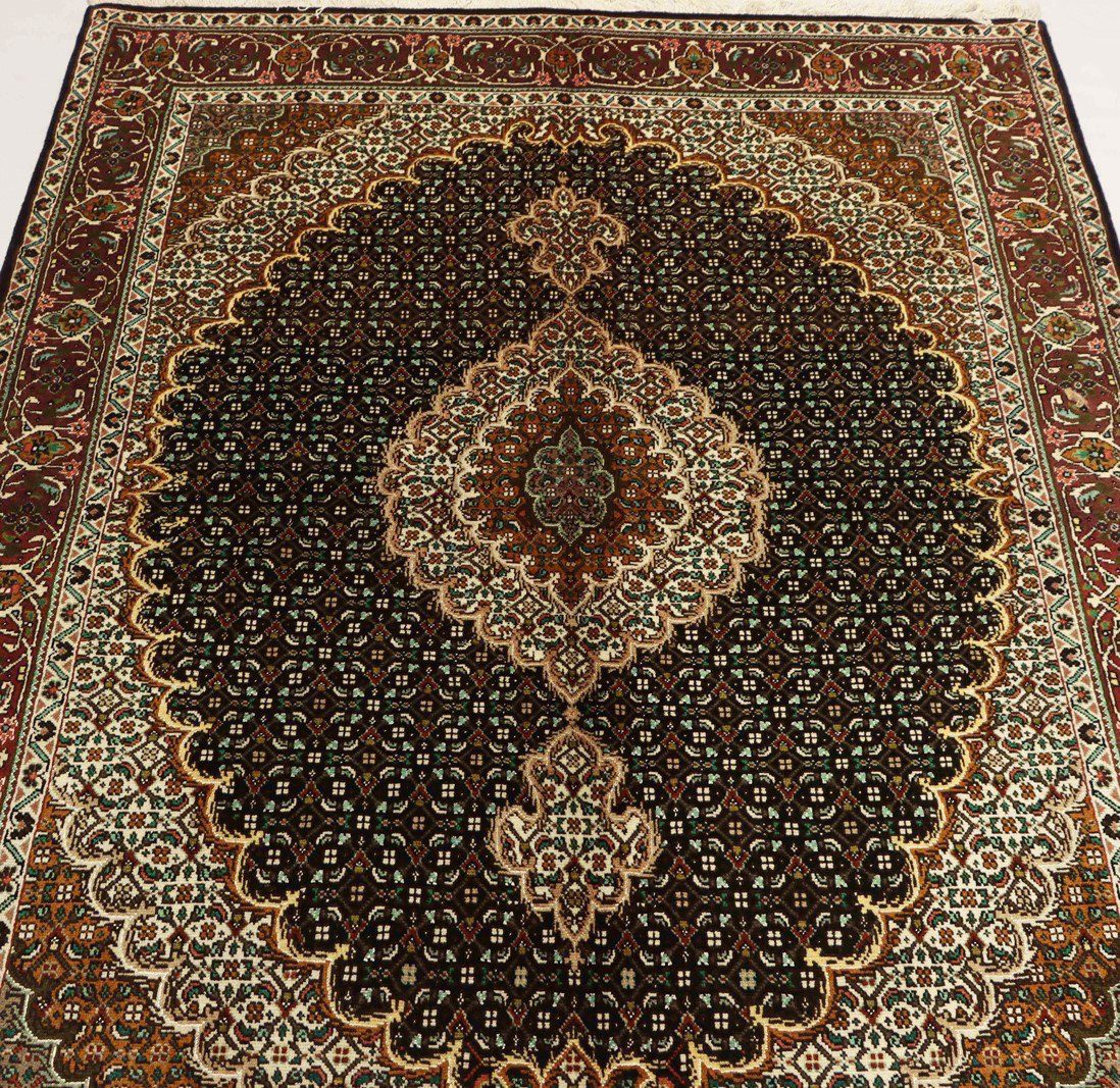 Antique Persian Tabriz rug with ornate geometric designs and rich, warm tones