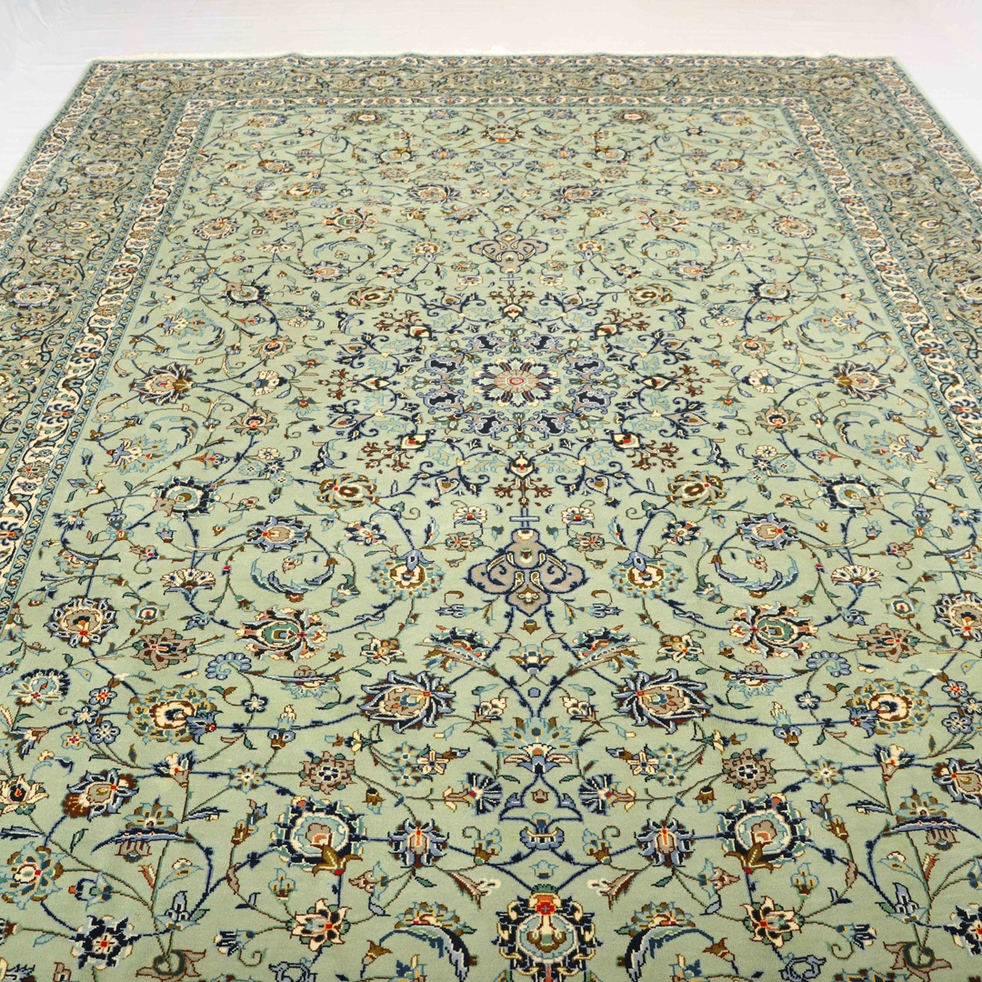 Close-up of a handmade traditional Persian rug with intricate floral designs and rich colors on display in a living room.