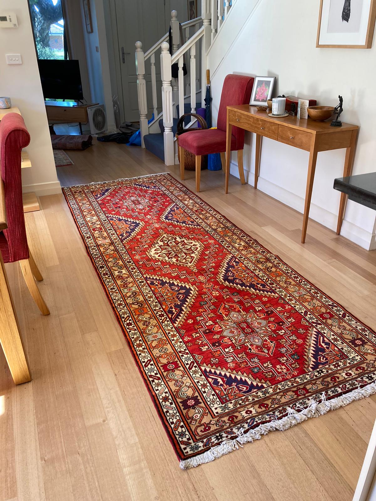 Image of a detailed Persian rug featuring a unique and intricate design. The rug's patterns and symbols reflect the culture and history of Iran, and tell a story through their meaning and symbolism. The use of a wide range of colors and precise weaving techniques require a high level of skill and artistry, making Persian rugs not only beautiful, but true works of art that contribute to their high cost.