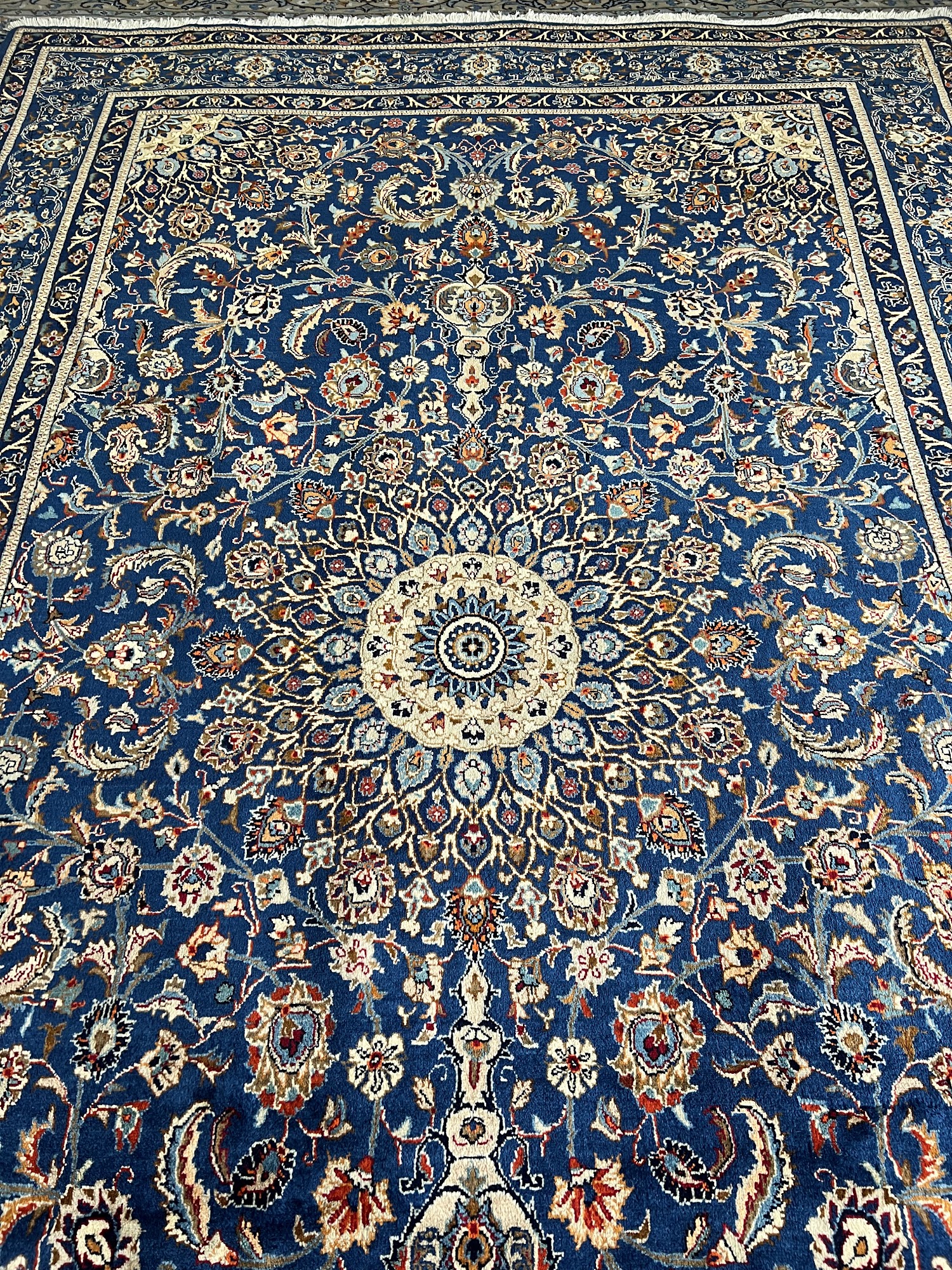 A beautifully decorated room featuring a blend of traditional and modern elements. An elegant Oriental rug serves as the centerpiece, seamlessly bridging the gap between classic and contemporary design styles. The rug's intricate patterns and rich colors harmonize with the room's aesthetic, creating a visually pleasing and cohesive atmosphere.